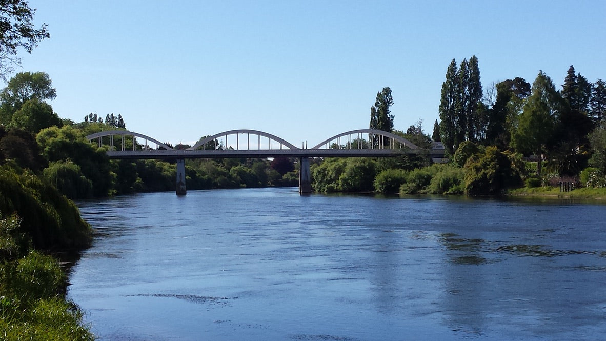 Photo of the Waikato River with the Fairfield Bridge in the background