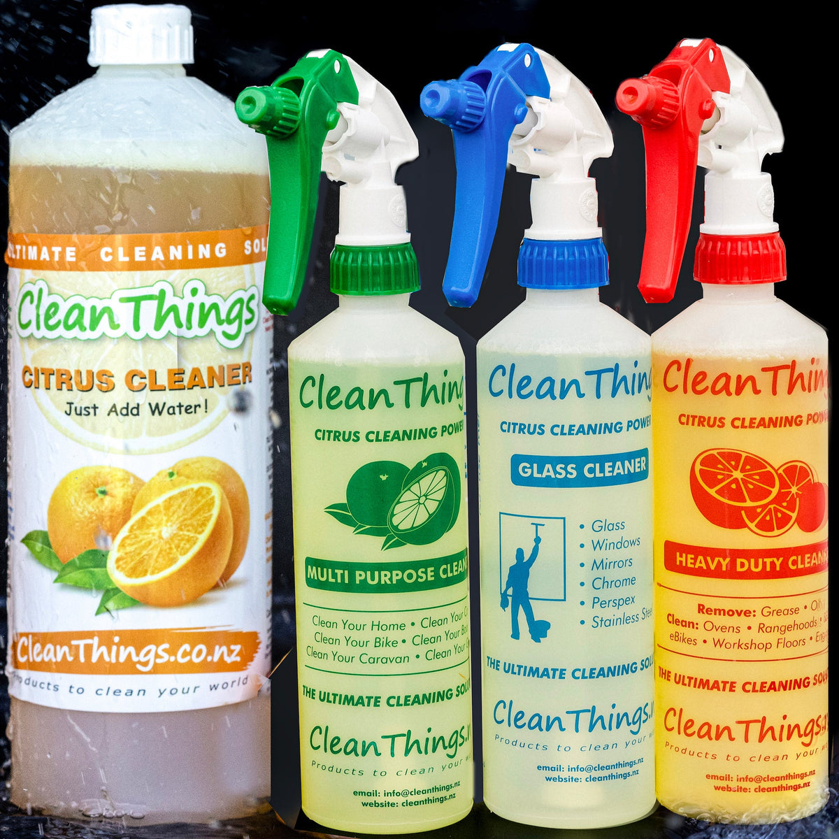 Citrus Cleaner 1 litre concentrate with green multi purpose, blue glass and red heavy duty spray bottles amid water splashes