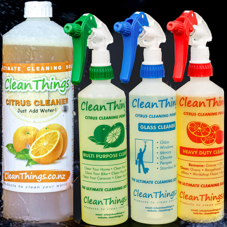 Citrus Cleaner 1 litre concentrate with green multi purpose, blue glass and red heavy duty spray bottles amid water splashes